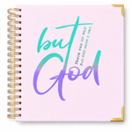 Notebook with 'but God' text on a pink cover