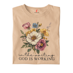TAN  t-shirt with floral design and text 'In the waiting God is working' on a white background