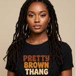 Woman wearing a black t-shirt with 'Pretty Brown Thang' text on a beige background