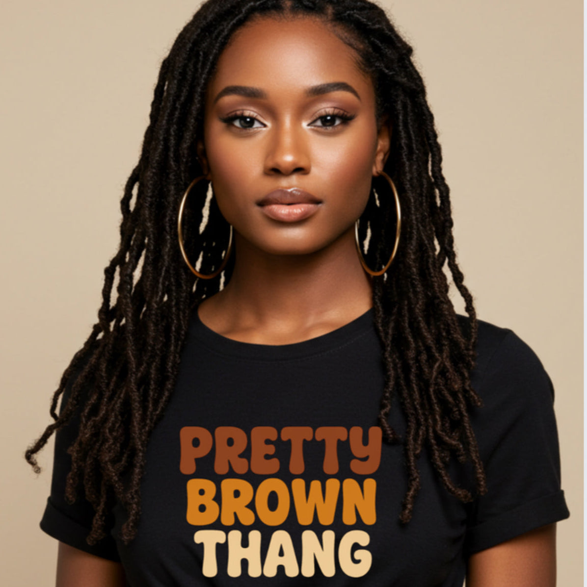Woman wearing a black t-shirt with 'Pretty Brown Thang' text on a beige background