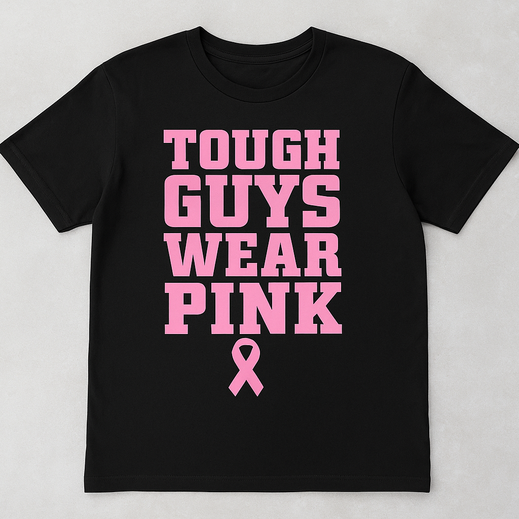 Black t-shirt with pink text and breast cancer awareness ribbon on a light gray background
