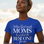 Woman wearing a blue t-shirt with a motivational quote against a blurred natural background