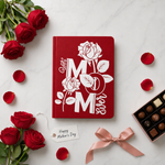 Red notebook with 'Best Mom Ever' text, surrounded by red roses and chocolates on a white background.