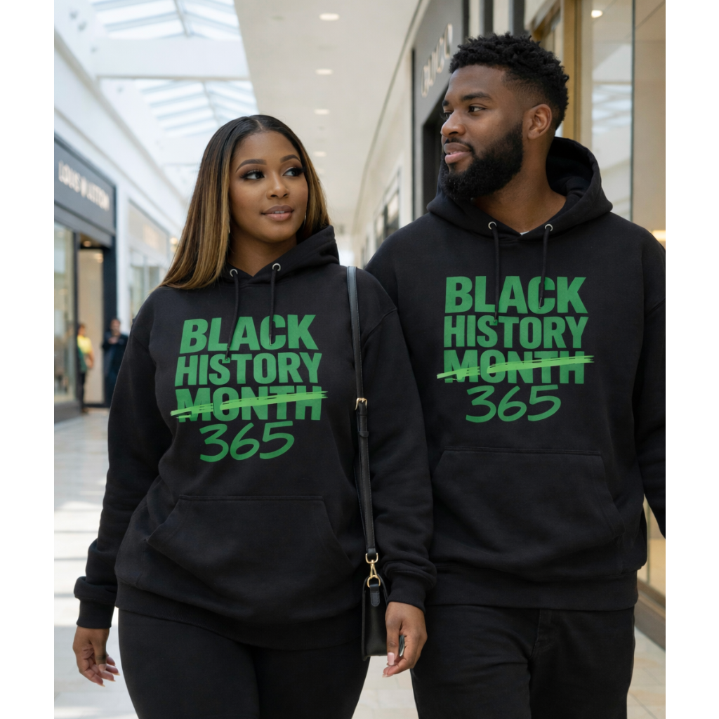 Two people wearing black hoodies with 'Black History Month 365' text in a shopping mall.