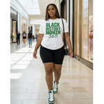 Woman wearing a 'Black History Month 365' t-shirt in a shopping mall.