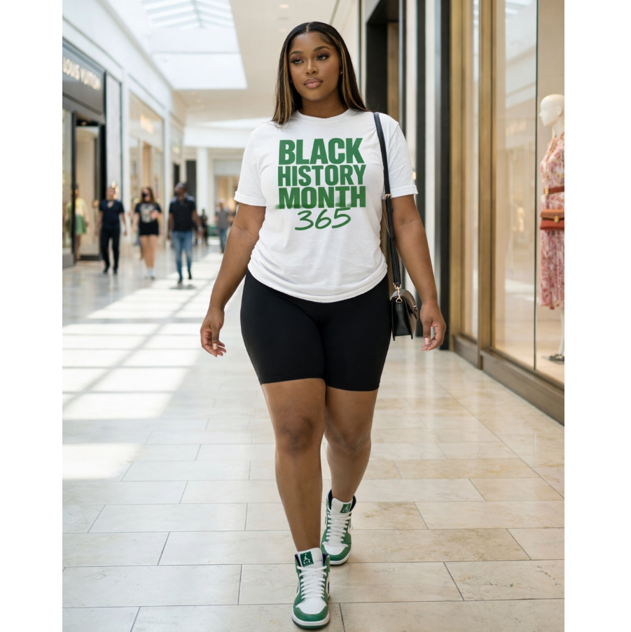 Woman wearing a 'Black History Month 365' t-shirt in a shopping mall.