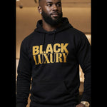 Man wearing a black hoodie with 'BLACK LUXURY' in gold text.