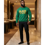 Man wearing a green 'Black Luxury' sweater in a mall setting