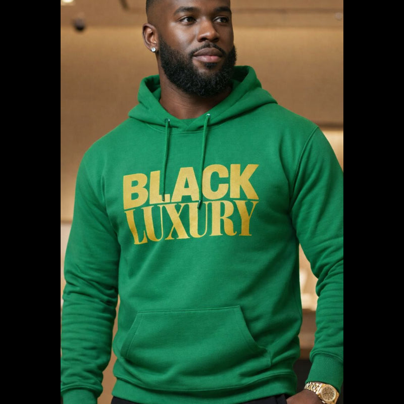 Person wearing a green hoodie with 'BLACK LUXURY' text, standing indoors.