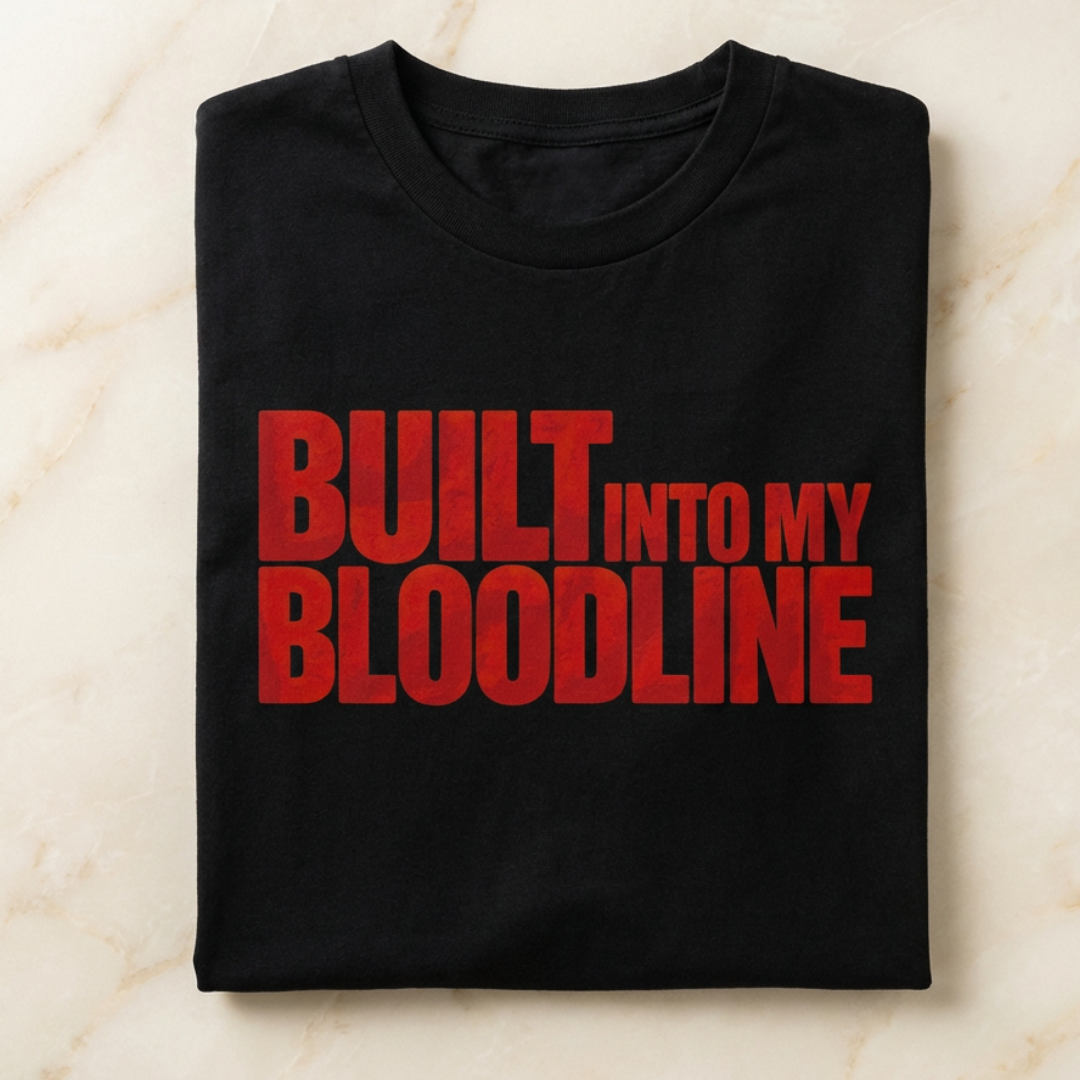 Black t-shirt with red text 'BUILT INTO MY BLOODLINE' on a light marble background
