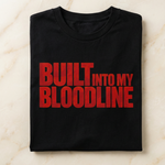 Black t-shirt with red text 'BUILT INTO MY BLOODLINE' on a light marble background
