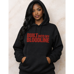 Person wearing a black hoodie with 'BUILT INTO MY BLOODLINE' text in red.
