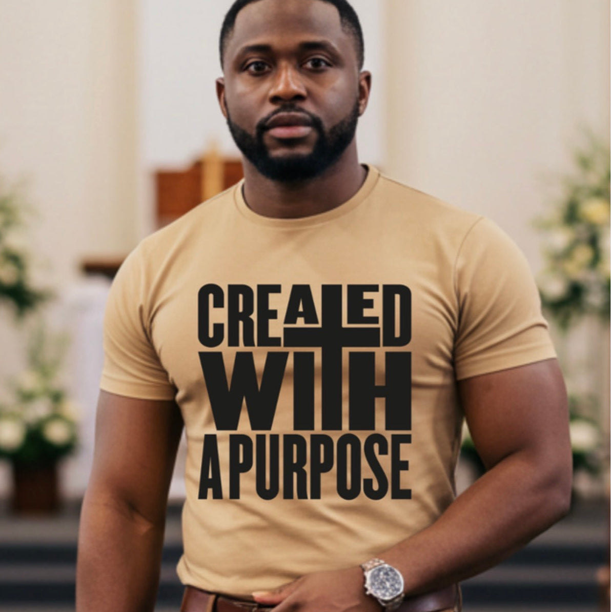 Man wearing a beige t-shirt with 'CREATED WITH A PURPOSE' text in a church setting