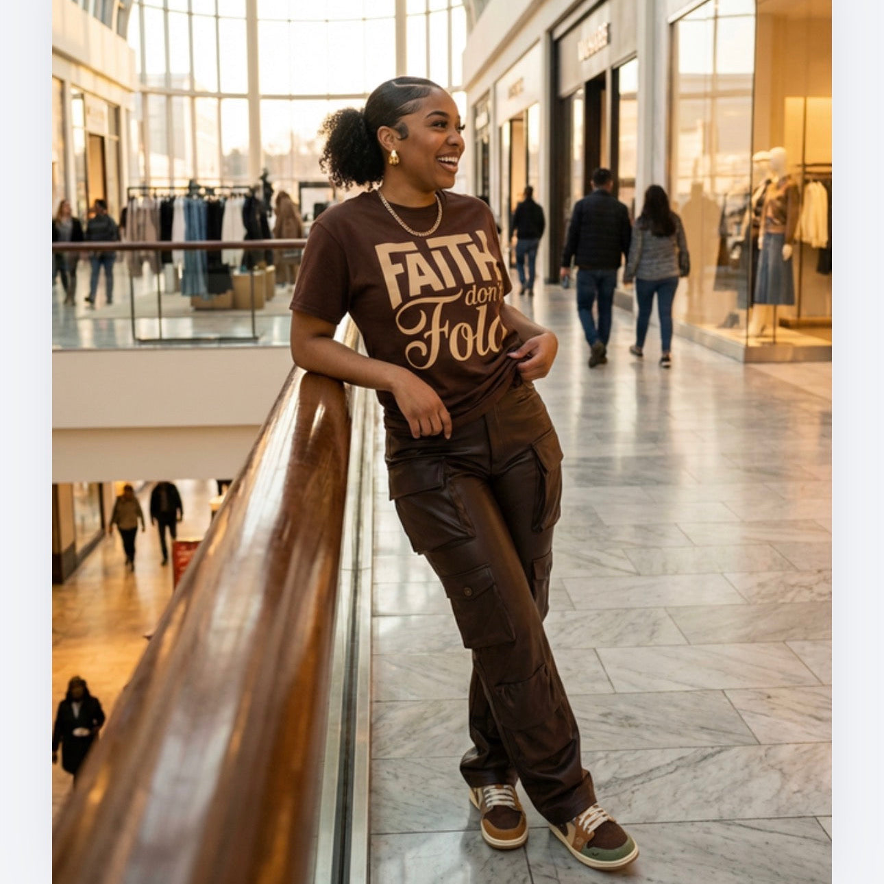 Woman in a mall wearing a brown t-shirt with 'Faith Over Fear' text.