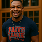 Man wearing a navy blue t-shirt with 'Faith League' text, standing in front of a wooden door.