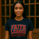 Person wearing a black t-shirt with 'Faith League' text and jeans indoors.