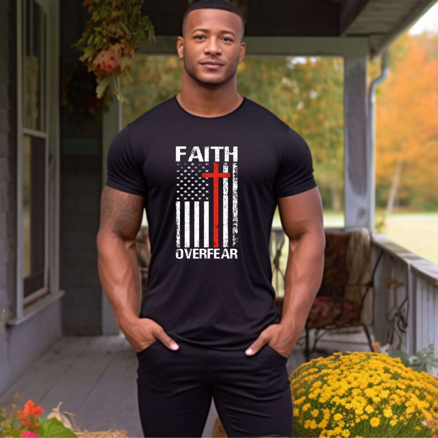 Man wearing a black t-shirt with 'Faith Over Fear' design on a porch with autumn decorations.