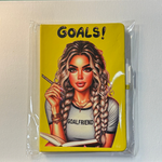 Notebook with an illustration of a woman holding a pencil and a notebook, with 'GOALS!' text on a yellow background.