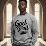 Man wearing a gray sweatshirt with 'God is Good all the time' text in an architectural setting