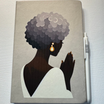 Notebook with a design of a woman with an afro on a beige background