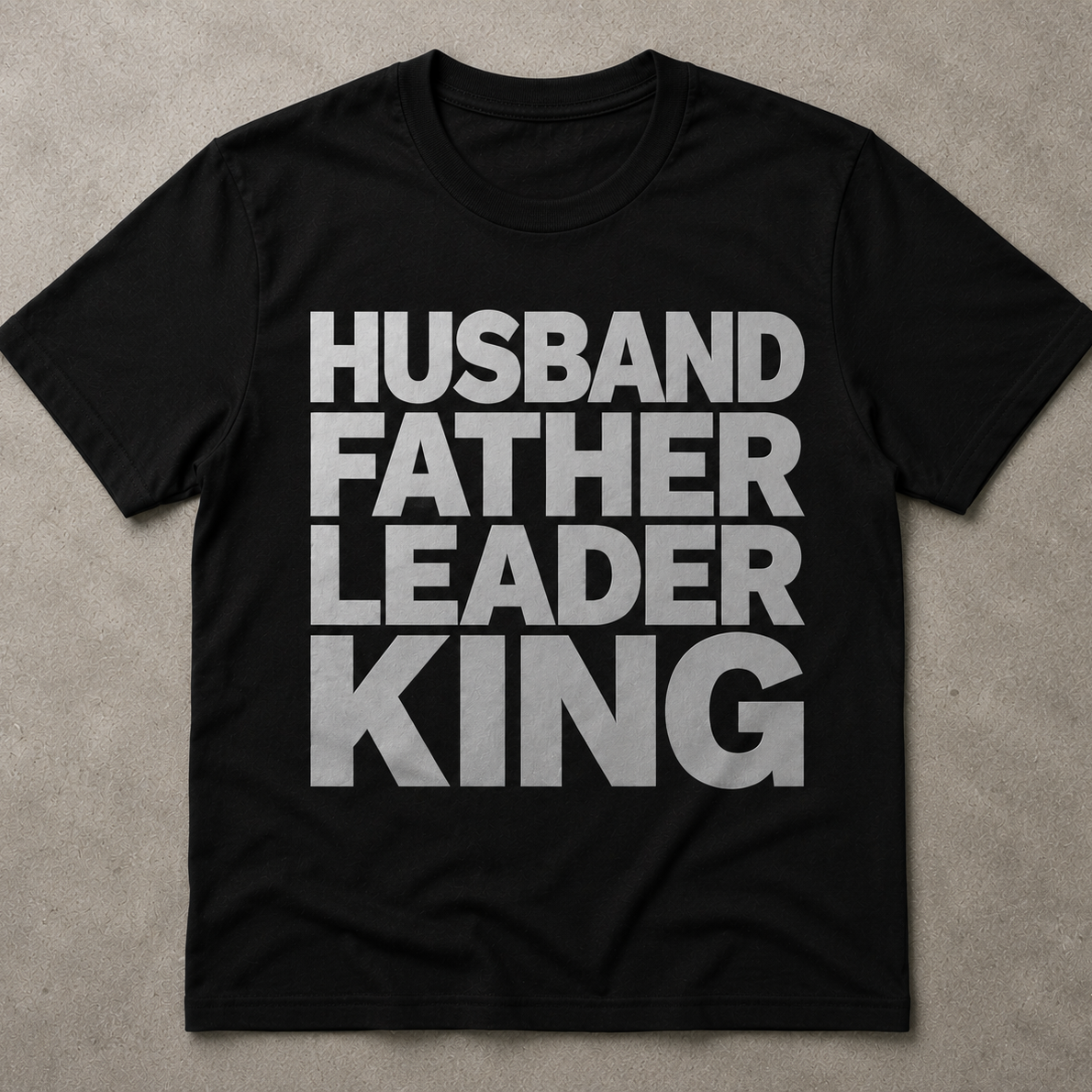 Black t-shirt with white text 'HUSBAND FATHER LEADER KING' on a beige background