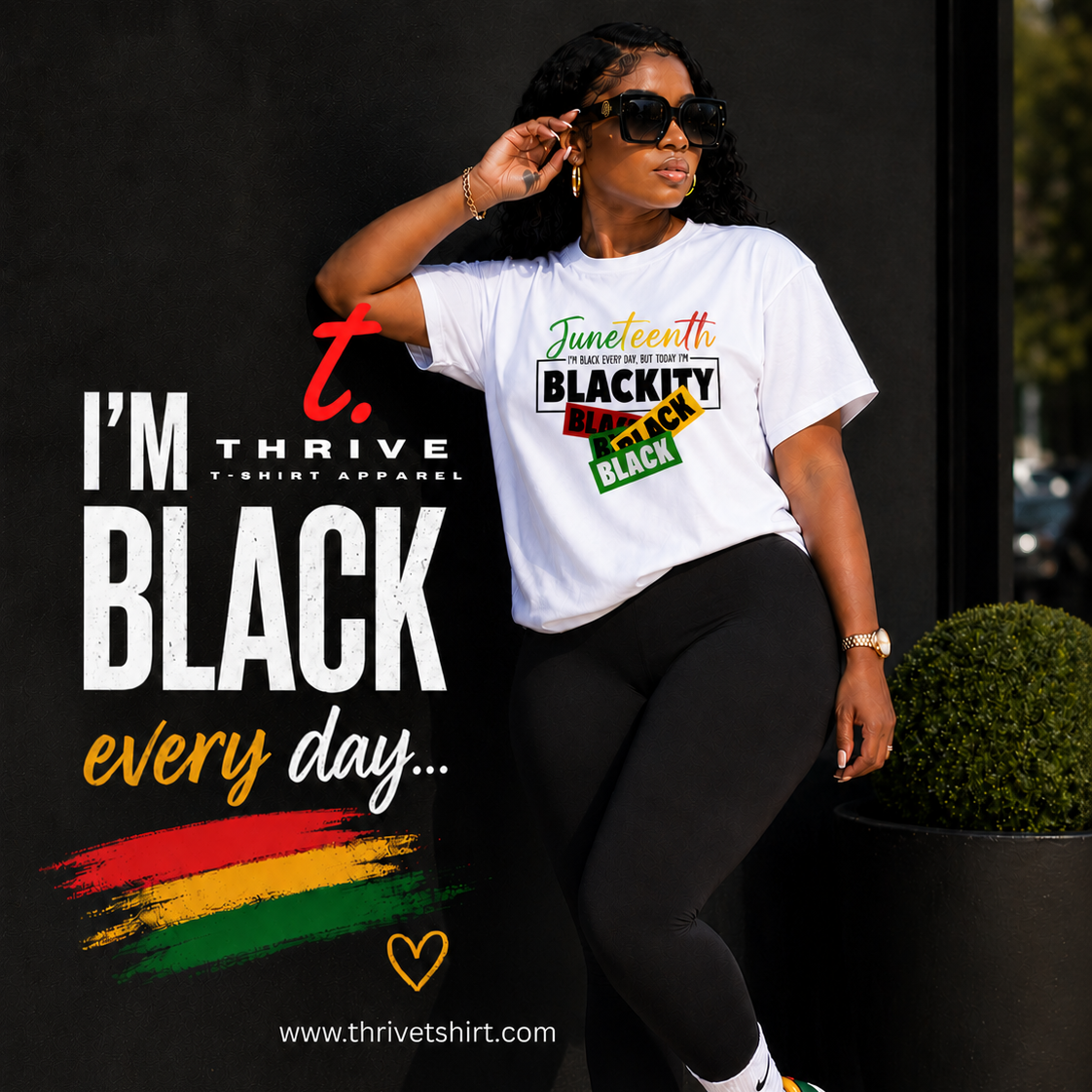 Woman wearing a white t-shirt with a message about Black pride, standing against a dark background.