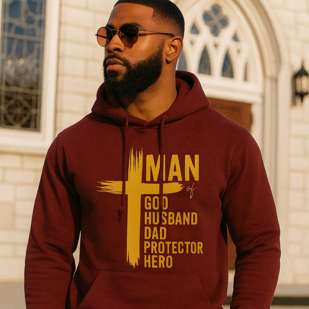 Man wearing a maroon hoodie with yellow text in front of a building.