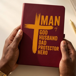 BURGANDY notebook with yellow text held by hands on a light background