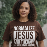 Person wearing a brown t-shirt with text in an outdoor setting