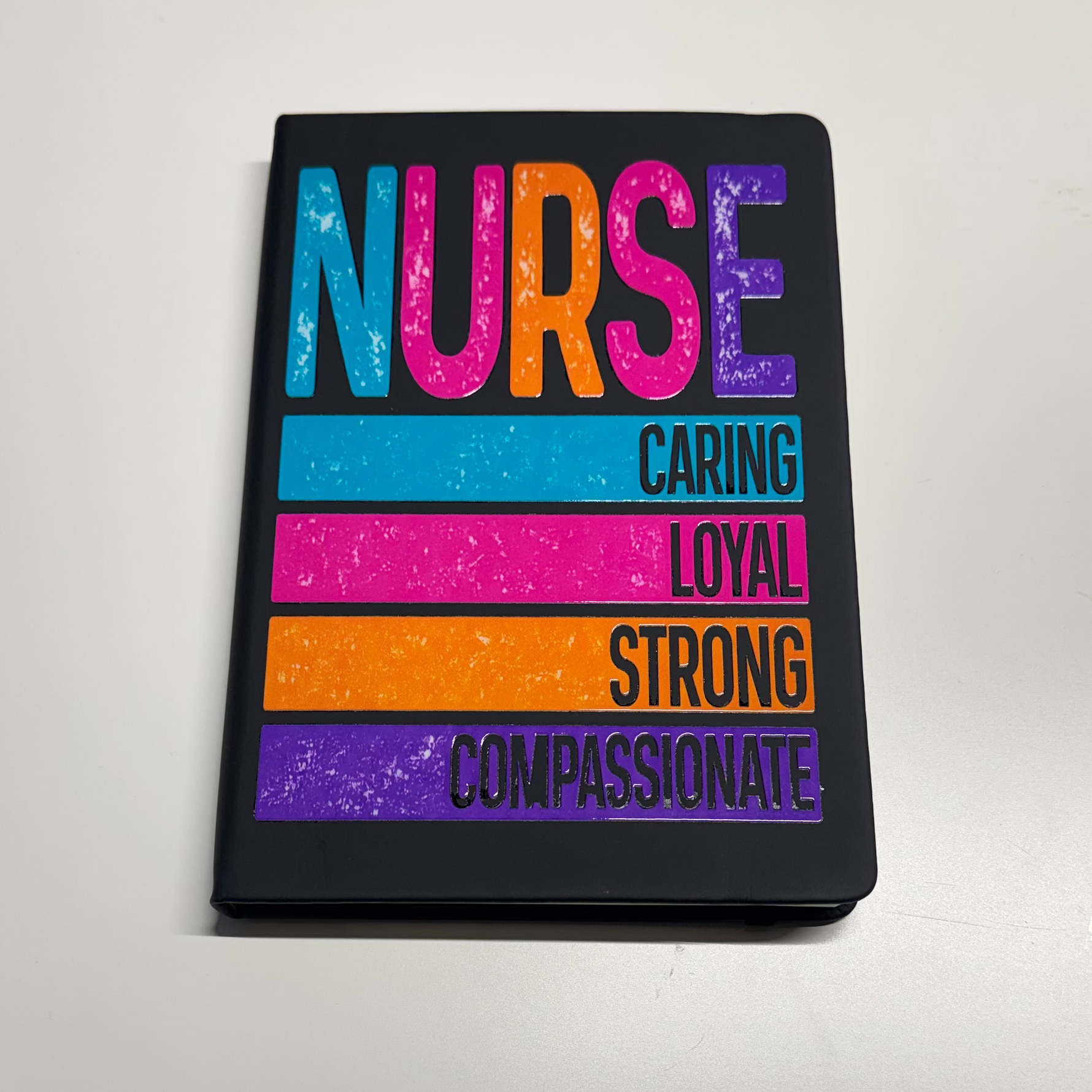 Notebook with colorful text on a white surface