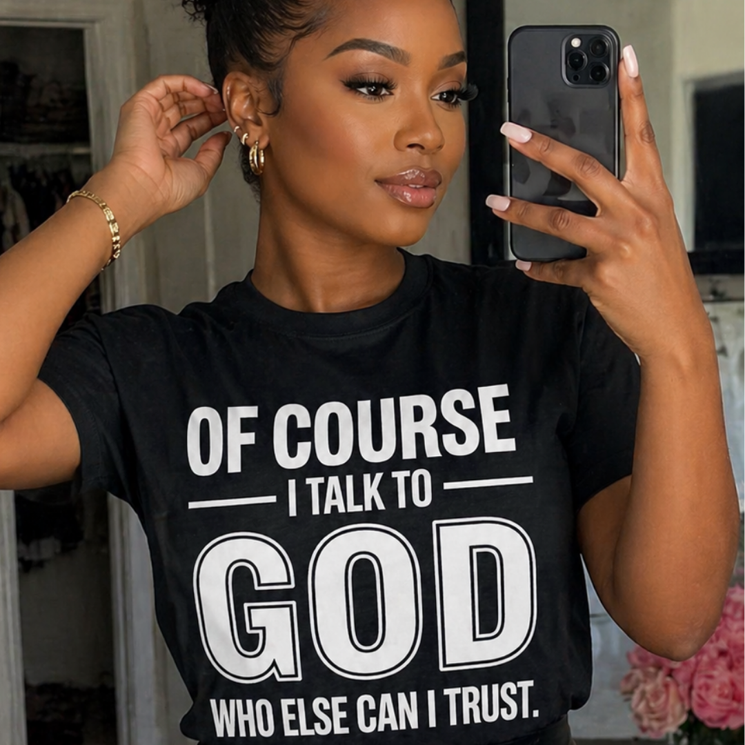 Woman wearing a black t-shirt with text, taking a mirror selfie.