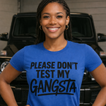 Person wearing a blue t-shirt with text standing in front of a vehicle.