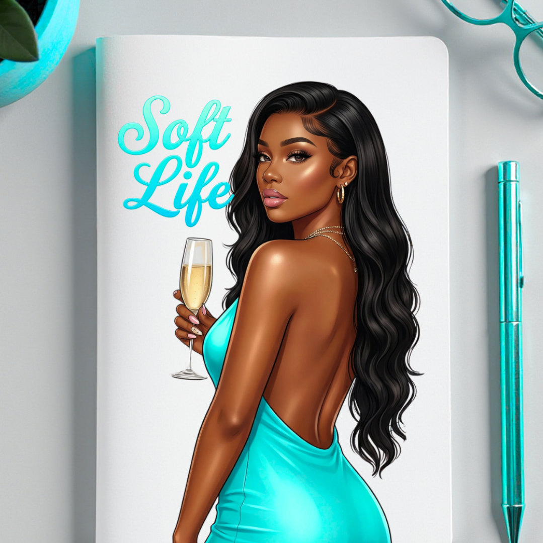 Notebook with a woman in a turquoise dress holding a glass of champagne, titled 'Soft Life', on a light gray background.