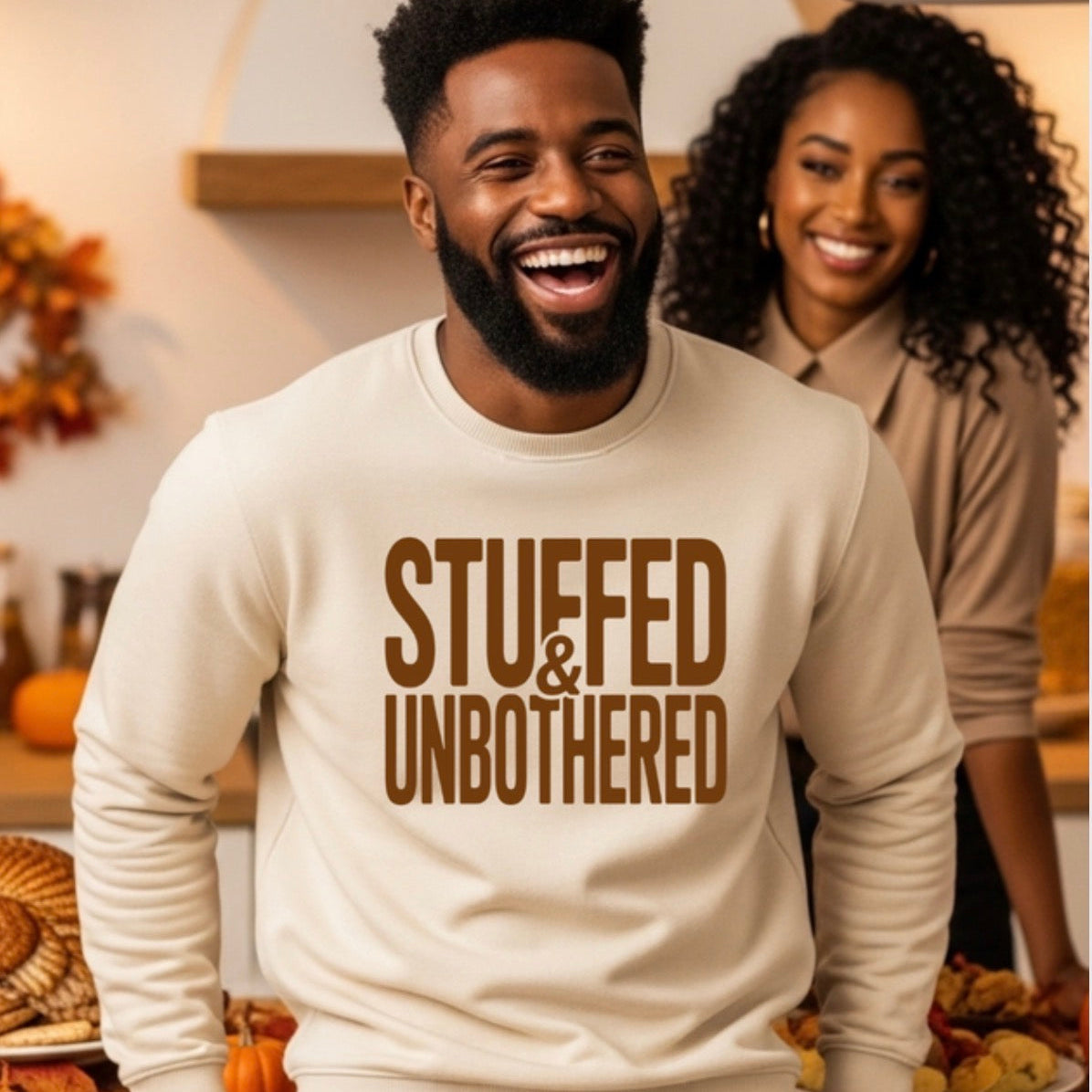Man wearing a 'Stuffed & Unbothered' sweatshirt in a festive setting.