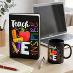 Desk setup with a tablet, laptop, and mug featuring educational-themed designs.