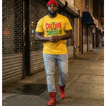 Man wearing a yellow t-shirt with text, standing on a city street.