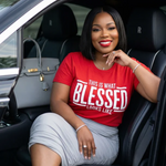 Woman sitting in a car wearing a red 'BLESSED' t-shirt