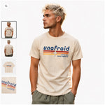 Man wearing a 'unafraid' t-shirt with colorful design on a white background