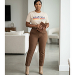 Woman wearing a 'unafraid' t-shirt in a living room setting