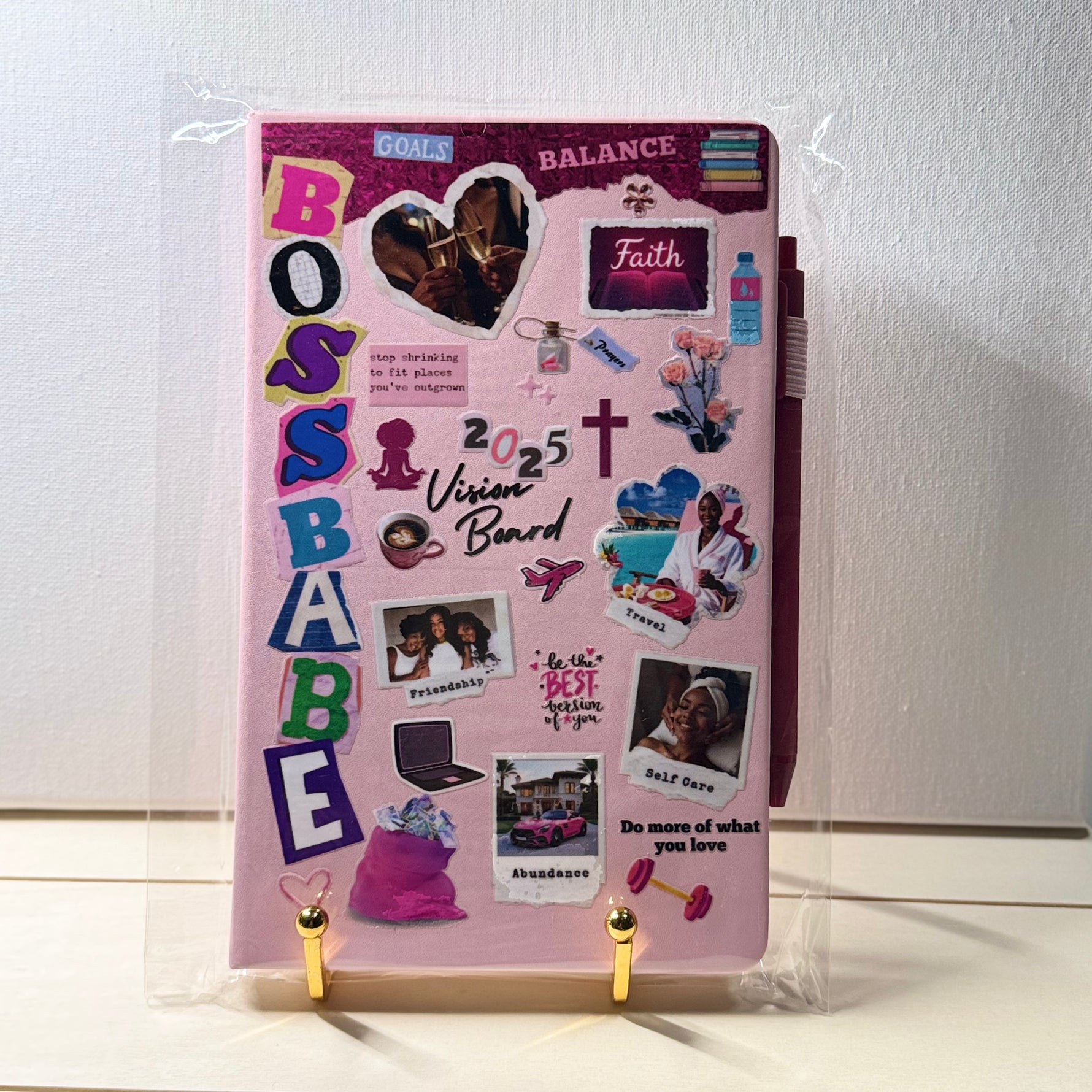 Pink vision board with various stickers and images on a white background