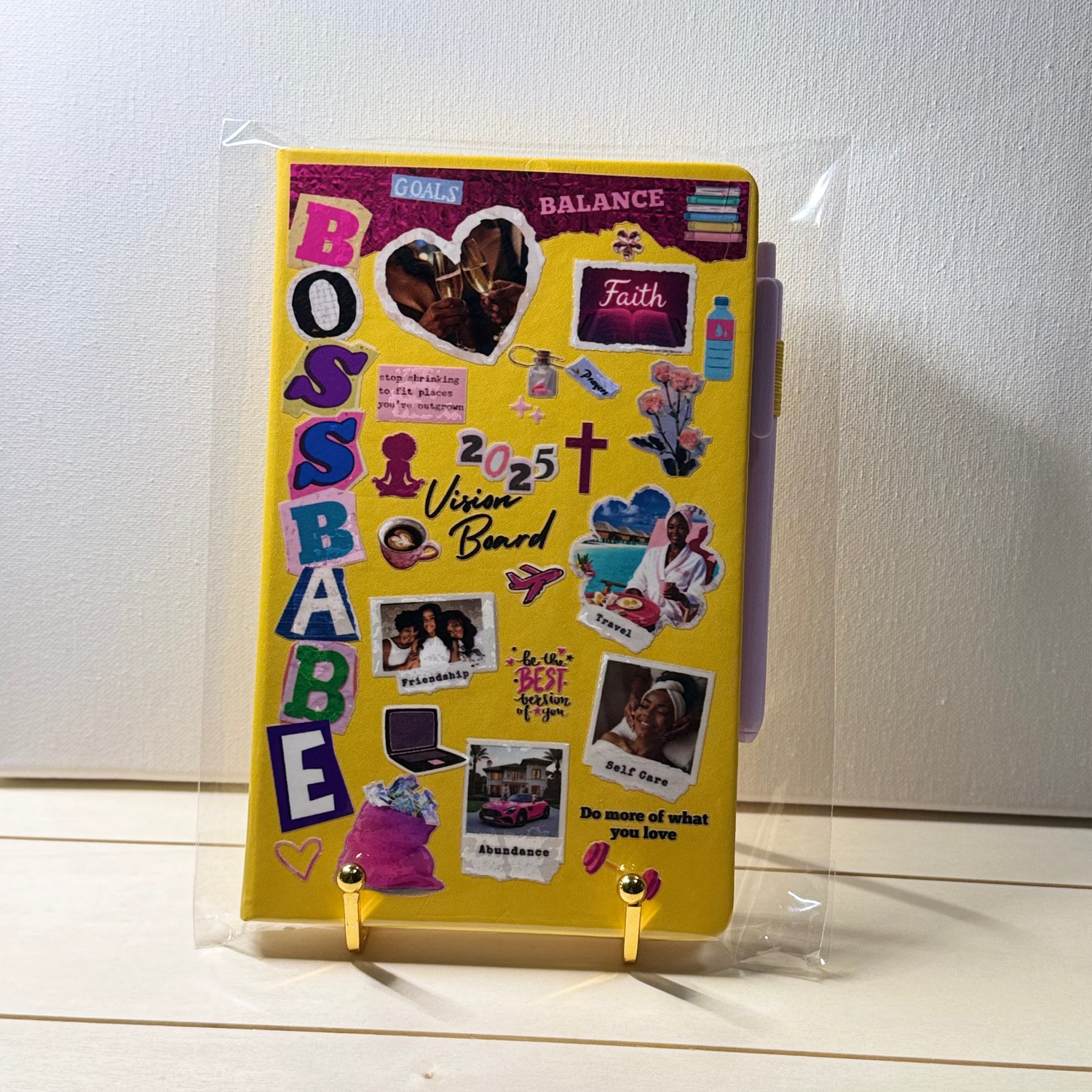 Yellow notebook with decorative stickers on a white surface