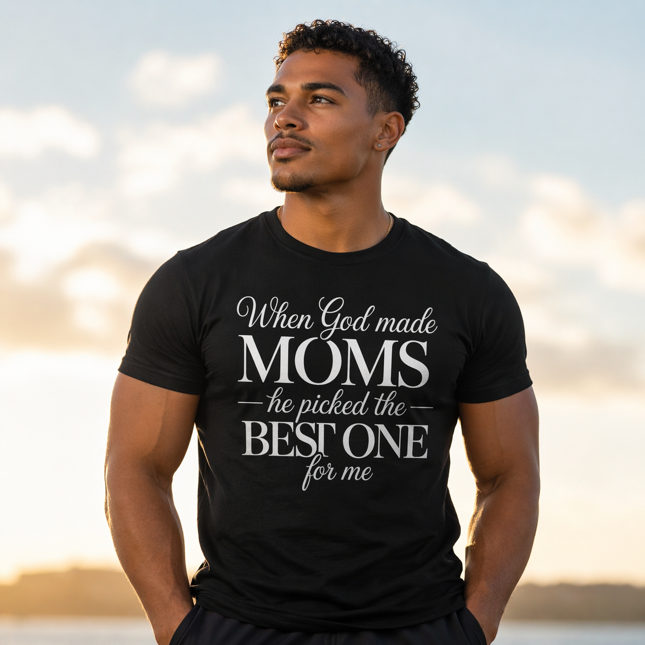 Man wearing a black t-shirt with a message about moms against a blurred natural background