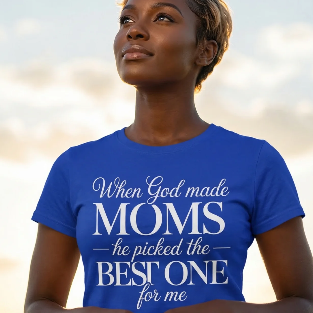 Woman wearing a blue t-shirt with a motivational quote against a blurred natural background