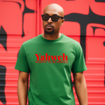 Man wearing a green t-shirt with 'Yahweh' text in red against a red and black graffiti wall.