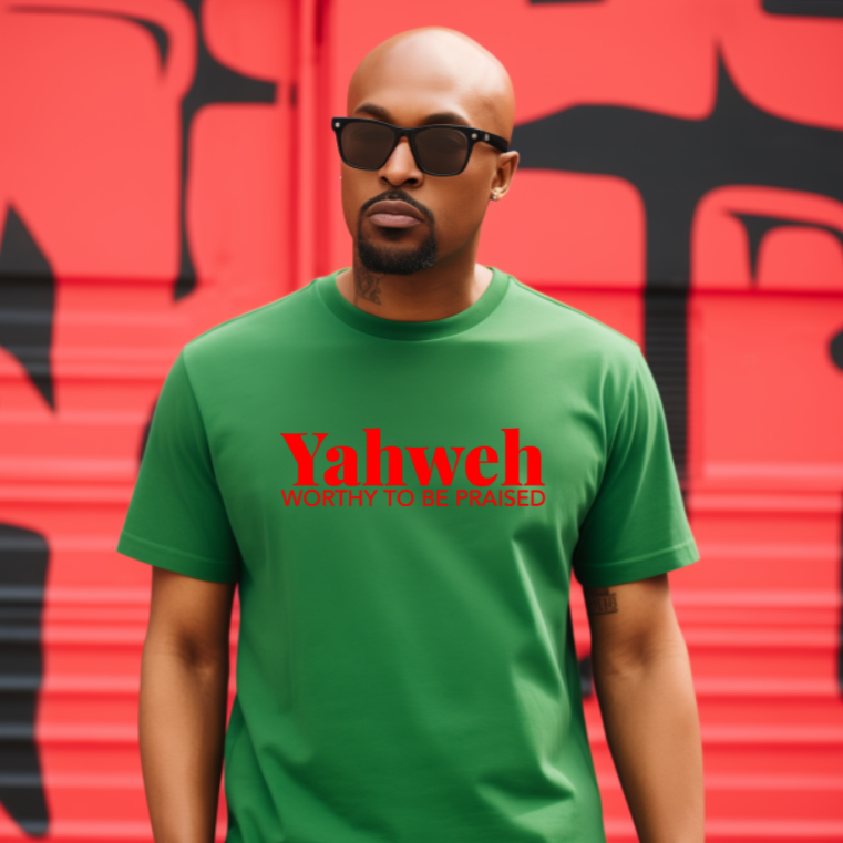 Man wearing a green t-shirt with 'Yahweh' text in red against a red and black graffiti wall.