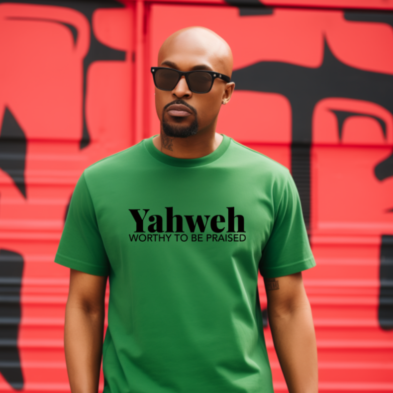 Man wearing a green t-shirt with 'Yahweh' text in front of a red and black graffiti wall.