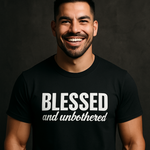 Man wearing a black t-shirt with 'Blessed and unbothered' text on a dark background