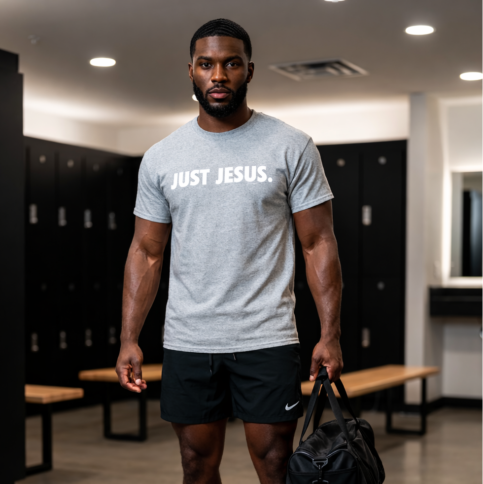 Man in a locker room wearing a 'Just Jesus' t-shirt and carrying a bag.