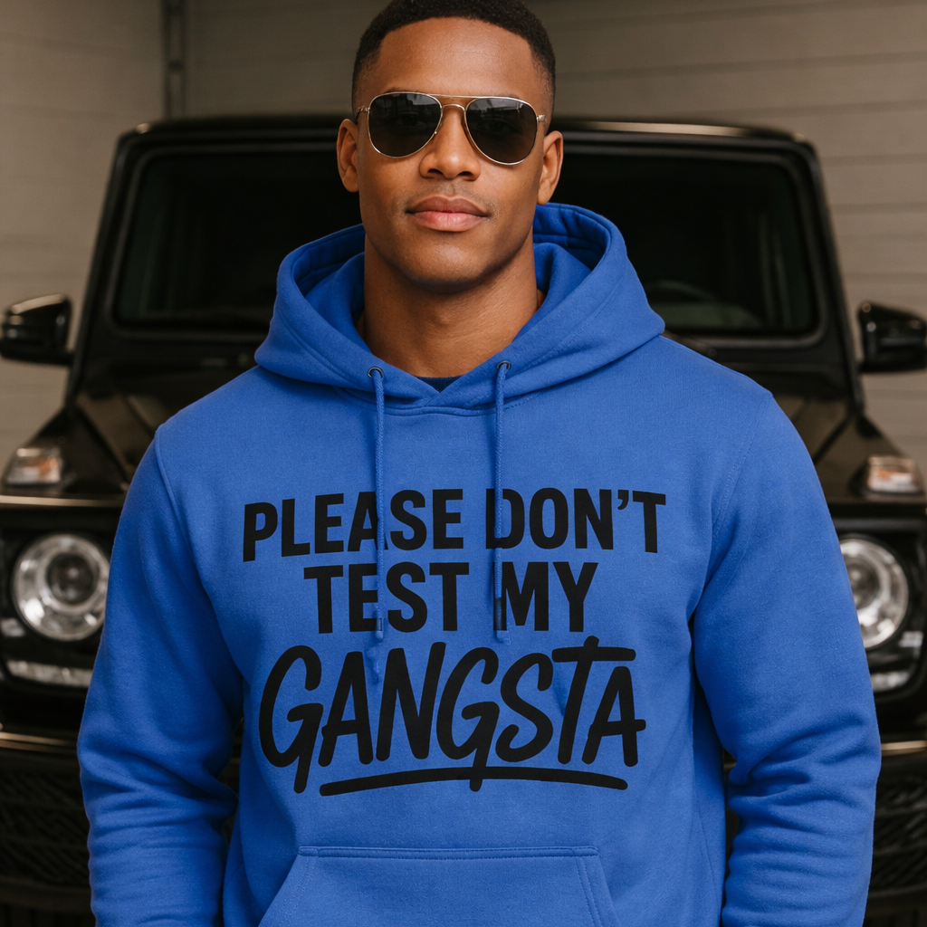 Man wearing a blue hoodie with text in front of a black SUV.