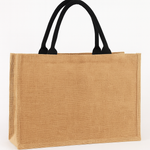 Beige jute bag with black handles on a white background